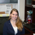 Bemiller sits at her desk located in the lower level of William A. Krueger Hall.